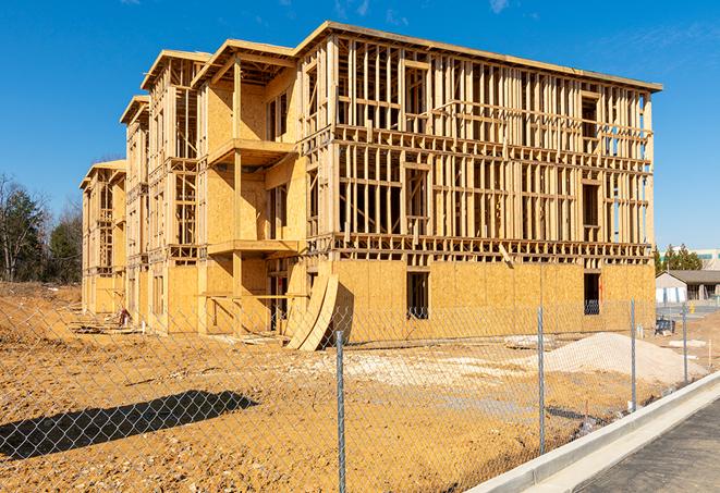 a job site enclosed by temporary chain link fences, ensuring safety for workers and pedestrians in Fayetteville